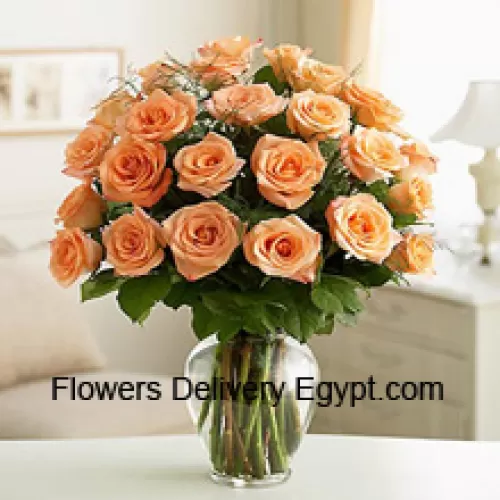 24 Peach Roses With Some Ferns In A Glass Vase